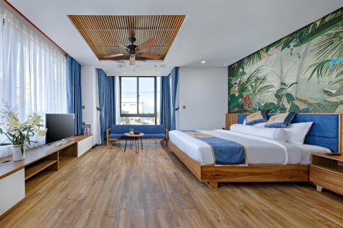 a hotel room with a large bed and a tv at Animor Green Home Villa Da Nang in Da Nang