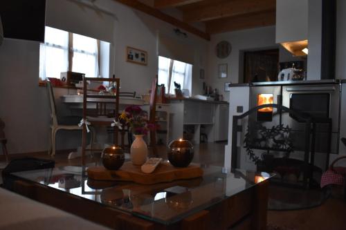 a living room with a table with flowers on it at Kraut & Ruabn - Stadl in Engabrunn