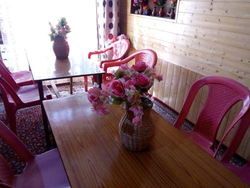 a table with a vase of flowers on it at Al Amin Homestay in Srinagar