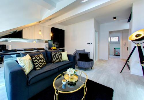 a living room with a blue couch and a table at Luxury apartment CRYSTAL in Mostar