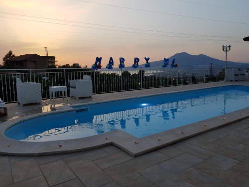 a swimming pool with people doing yoga on a fence at B&B Villa Catiè in Castellammare di Stabia