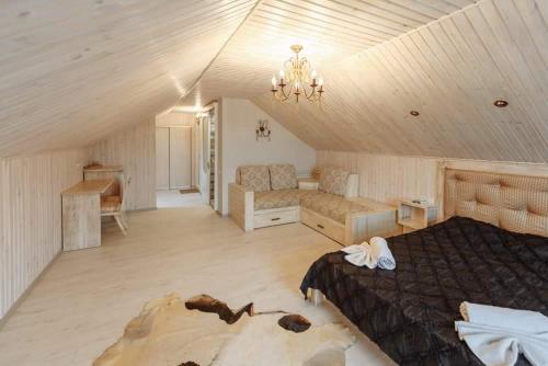 a bedroom with a bed and a couch in a room at Бутик 2017 in Bilhorod-Dnistrovskyi