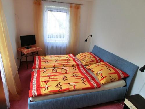 a bedroom with a bed with a blanket on it at Vila Evička in Sobotka