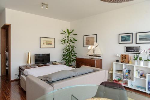 a bedroom with a large bed and a tv at Porto D´Ouro Apartments in Porto