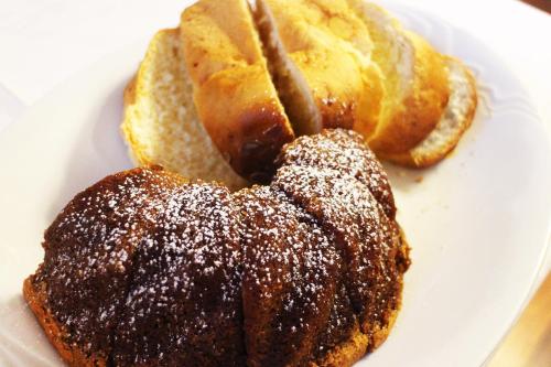 two pastries on a white plate with powdered sugar at Marben Panzió in Hegykő