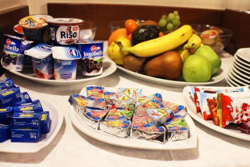 a table topped with plates of food and fruit at Marben Panzió in Hegykő