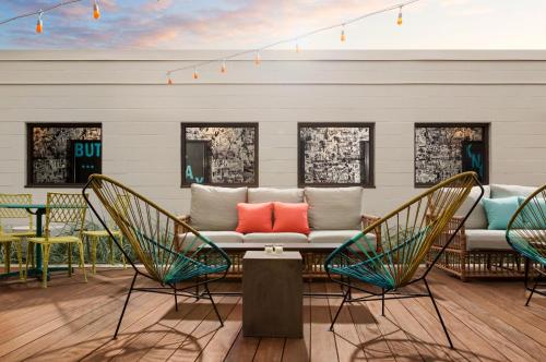a patio with a couch and chairs and a table at Studio Allston Hotel Boston in Boston
