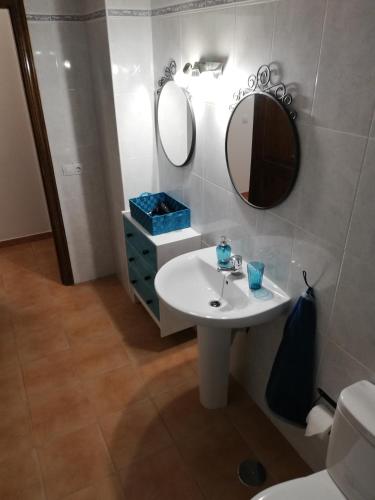 a bathroom with a sink and two mirrors at mirador del roque 2 in Órzola