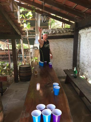 a man standing next to a table with cups on it at Hair of the Dog in Varna City