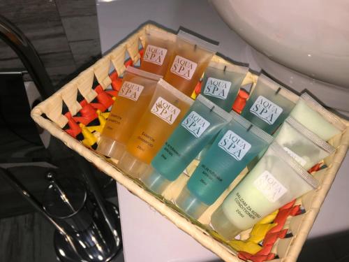 a basket filled with different types of hair products at Kristal Apartmani in Arandjelovac