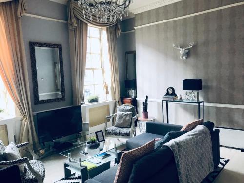 a living room with a couch and a tv at City Centre Georgian Style Apartment in Dublin