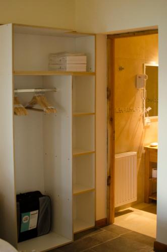 a book shelf in a room with a closet at ALEHUE Casa de Montaña in Villa La Angostura