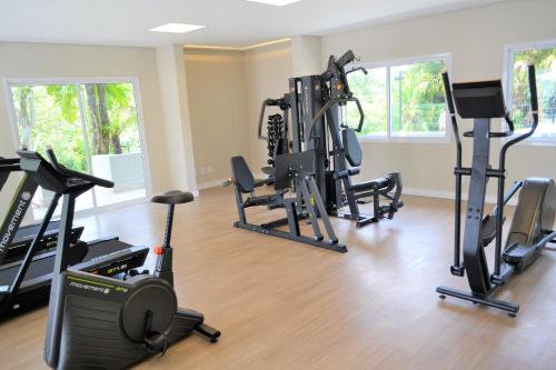 a gym with treadmills and exercise equipment in a room at Alegro Hotel in Jarinu