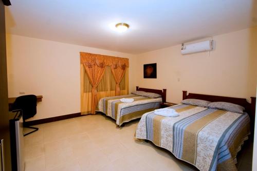 Postel nebo postele na pokoji v ubytování Hotel El Cerro