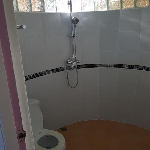 a bathroom with a shower and a toilet at Sunrise Beach Resort in Ko Chang