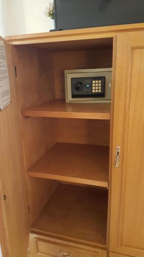 a wooden cabinet with a microwave in it at La Casona in Federación