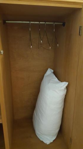 a pillow in a room with a wooden wall at La Casona in Federación