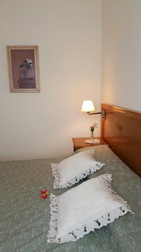 a bedroom with a bed with pillows on it at La Casona in Federación
