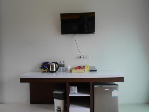 a desk in a room with a tv on the wall at Gypsy Sea View Resort- Phi Phi Island in Phi Phi Don