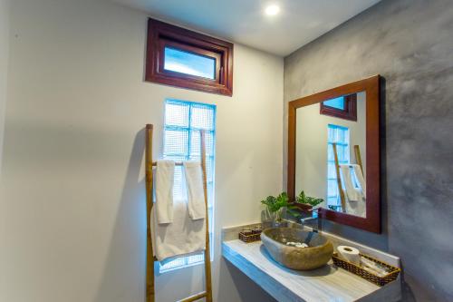 a bathroom with a sink and a mirror at The Shoreline Stay in Hoi An