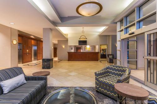 a living room filled with furniture and a tv at Wyndham Garden Buffalo Downtown in Buffalo