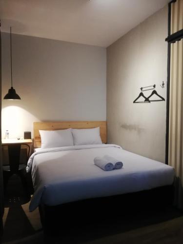 a bedroom with a bed with two towels on it at PINX'S HOSTEL in Jakarta