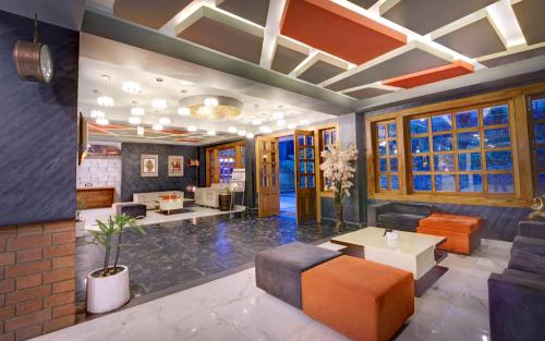 a lobby with a couch and a table at Udaan Woodberry Hotel & Spa in Gangtok