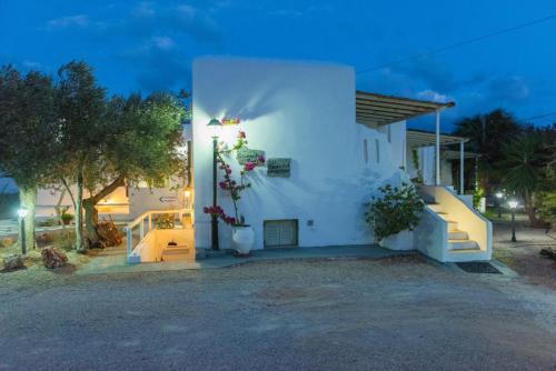 a white house with flowers on the side of it at Giannakas Studios in Platis Yialos Sifnos
