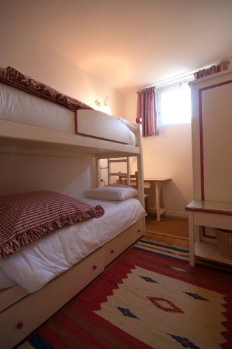 a bedroom with two bunk beds and a window at Castello di Vezio in the Village in Varenna