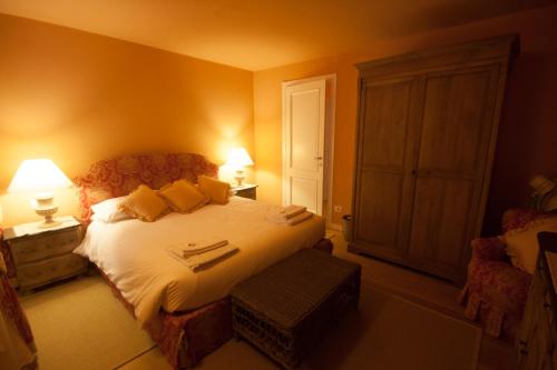 a bedroom with a bed and a chair and lamps at Castello di Vezio in the Village in Varenna