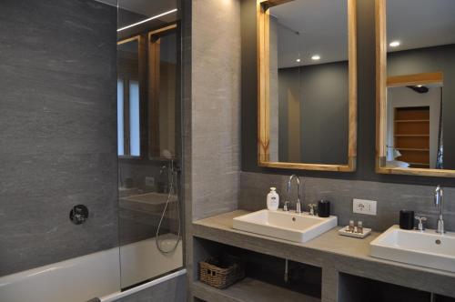 a bathroom with two sinks and a shower at Castello di Vezio in the Village in Varenna