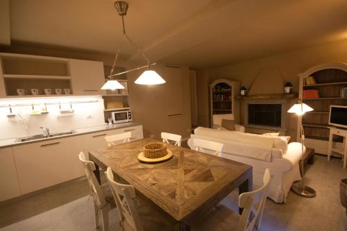 a kitchen and living room with a table and a couch at Castello di Vezio in the Village in Varenna