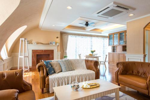 a living room with a couch and a table at Enoca Hotel in Fujisawa