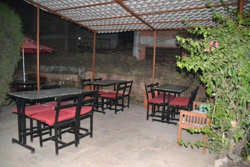 a group of tables and chairs in a patio at Pradhan House - Home Stay with Garden in Bhaktapur