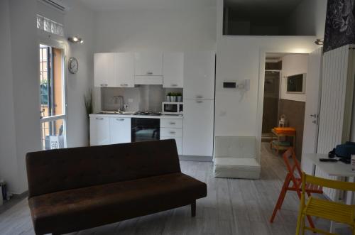 a living room with a couch and a kitchen at Stayinbologna in Bologna