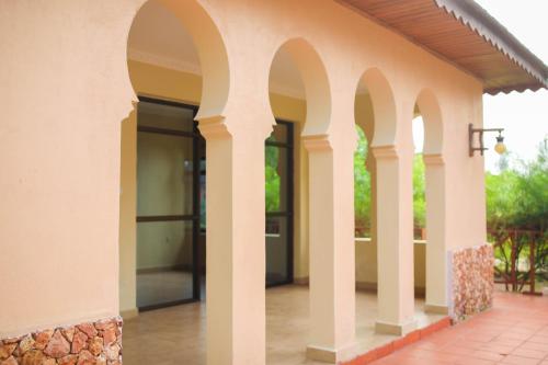 an external view of a building with arches at VRclub Paje Palms Beach Resort in Paje