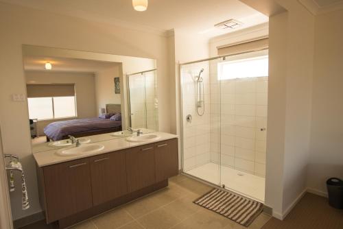 a bathroom with two sinks and a shower at Apple House Point Cook in Point Cook