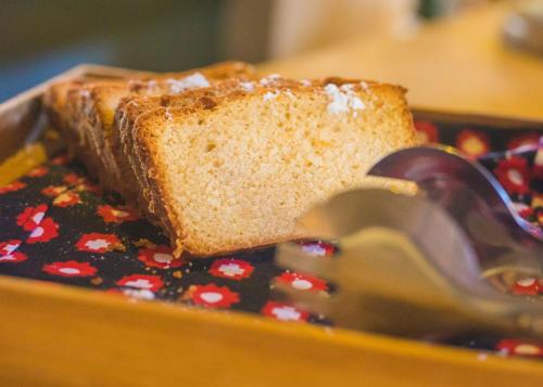 a piece of bread on a plate with a pair of scissors at VRclub Paje Palms Beach Resort in Paje