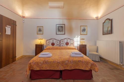 a bedroom with a large bed with towels on it at BolognaRoomscom - Ca' Palazzo in Sasso Marconi
