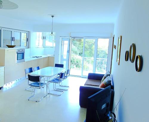 a kitchen and dining room with a table and chairs at Dimitra Apartments K in Kommeno