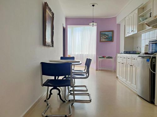 a kitchen with a table and chairs in a room at Dimitra Apartments K in Kommeno