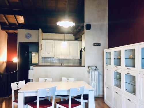 a kitchen with a white table and white cabinets at Locanda dell'Arcangelo in Rocca Massima
