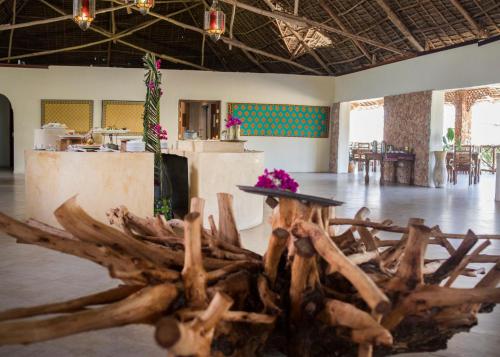 a room with a table and a pile of wood at VRclub Paje Palms Beach Resort in Paje