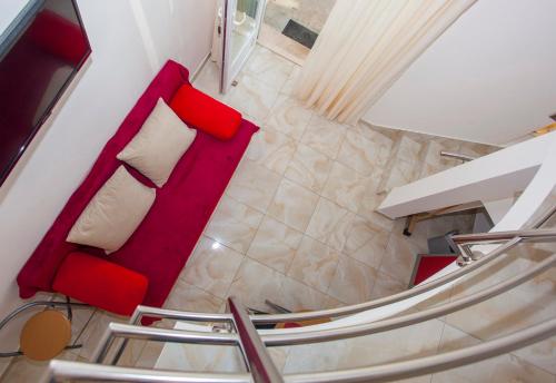 a red couch with a white pillow in a room at Apartments Lara in Podgora