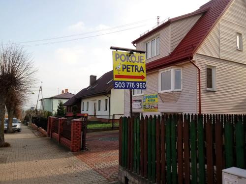 a house with a sign for a potato potato pitaoss tgif sign at Pokoje PETRA pod Bocianem in Supraśl