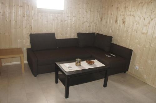a living room with a couch and a coffee table at Kalv-Fegen 1 in Kalv
