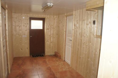 a room with wooden walls and a door at Kalv-Fegen 1 in Kalv