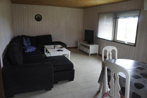 a living room with a couch and a table at Kalv-Fegen 1 in Kalv