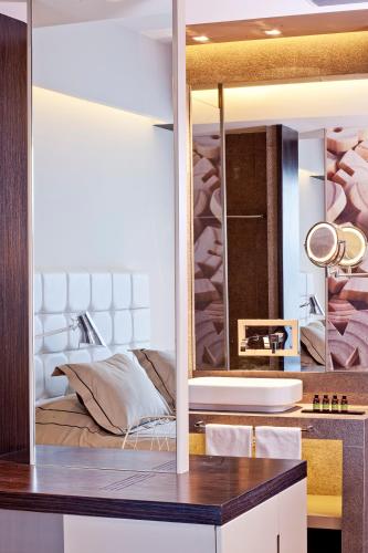 a bathroom with a sink and a mirror at Aqua Blu Boutique Hotel & Spa, Adults Only- Small Luxury Hotels of the World in Kos