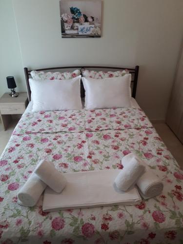 a bed with two pairs of socks and shoes on it at Villa Anastasia in Keramoti